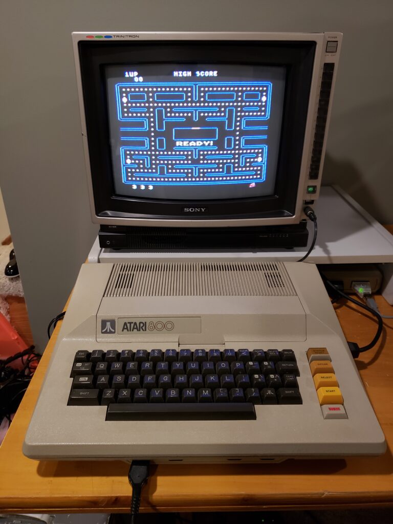 Atari 800 computer connected to a 13" Sony TV displaying the game Pac-Man